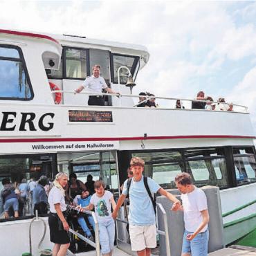 Fahnen hoch bei Sonnenaufgang - Die Passagiere werden nach dem Anlegen freundlich verabschiedet und beim Verlassen des Schiffes von oben herab gezählt.