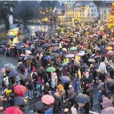 Mit Schirm und Charme - Die 60 Schmutzli, 10 Dienerinnen und Diener in Weiss und 10 Samichläuse stehen auf der Kirchentreppe bereit. Sie bahnen sich bald den Weg durch die 700 Menschen, die voller Vorfreude und im Regen warten. Bilder: Stefan Sprenger