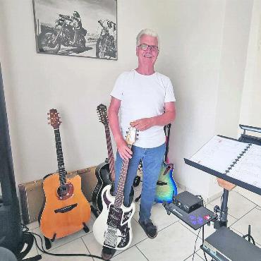 Von Gitarrenriffs getragen - Guido Ursprung lebt auf, wenn er über seine Instrumente im Musikzimmer erzählt. Bild: Verena Anna Wigger