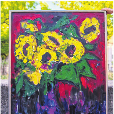 Sonniger Gruss - Giani Castiglionis Sonnenblume: Links bereit zum Aufhängen, rechts als strahlender Sonnengruss im Schaufenster der Gemeinde. 
Bilder: zg